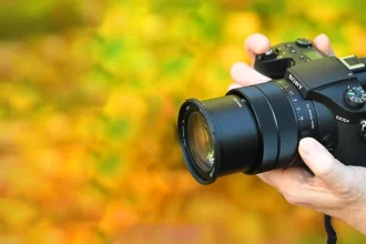 A selection of top 2024 bridge cameras showcasing large zoom lenses, electronic viewfinders, and ergonomic designs, arranged in a studio setting.
