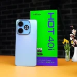 The Infinix Hot 40i smartphone displayed against a colorful gradient background, showing its side-mounted fingerprint sensor and glossy back panel.