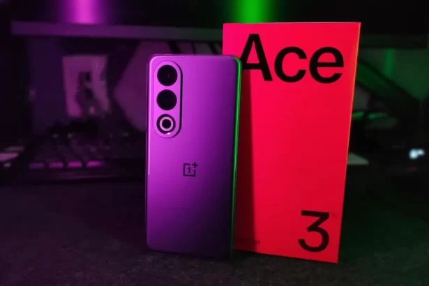 A sleek OnePlus Ace 3V smartphone in Titanium Gray or Purple, featuring a 6.74-inch AMOLED display with 120Hz refresh rate. The rear has a dual-camera setup (50MP main + 8MP ultra-wide) housed in a vertical module, alongside the OnePlus logo. The front showcases a 16MP selfie camera centered in a slim bezel. The device is shown on a flat surface, screen displaying vibrant wallpaper, with a charging cable and power adapter beside it. The signature OnePlus alert slider is visible on the right edge.