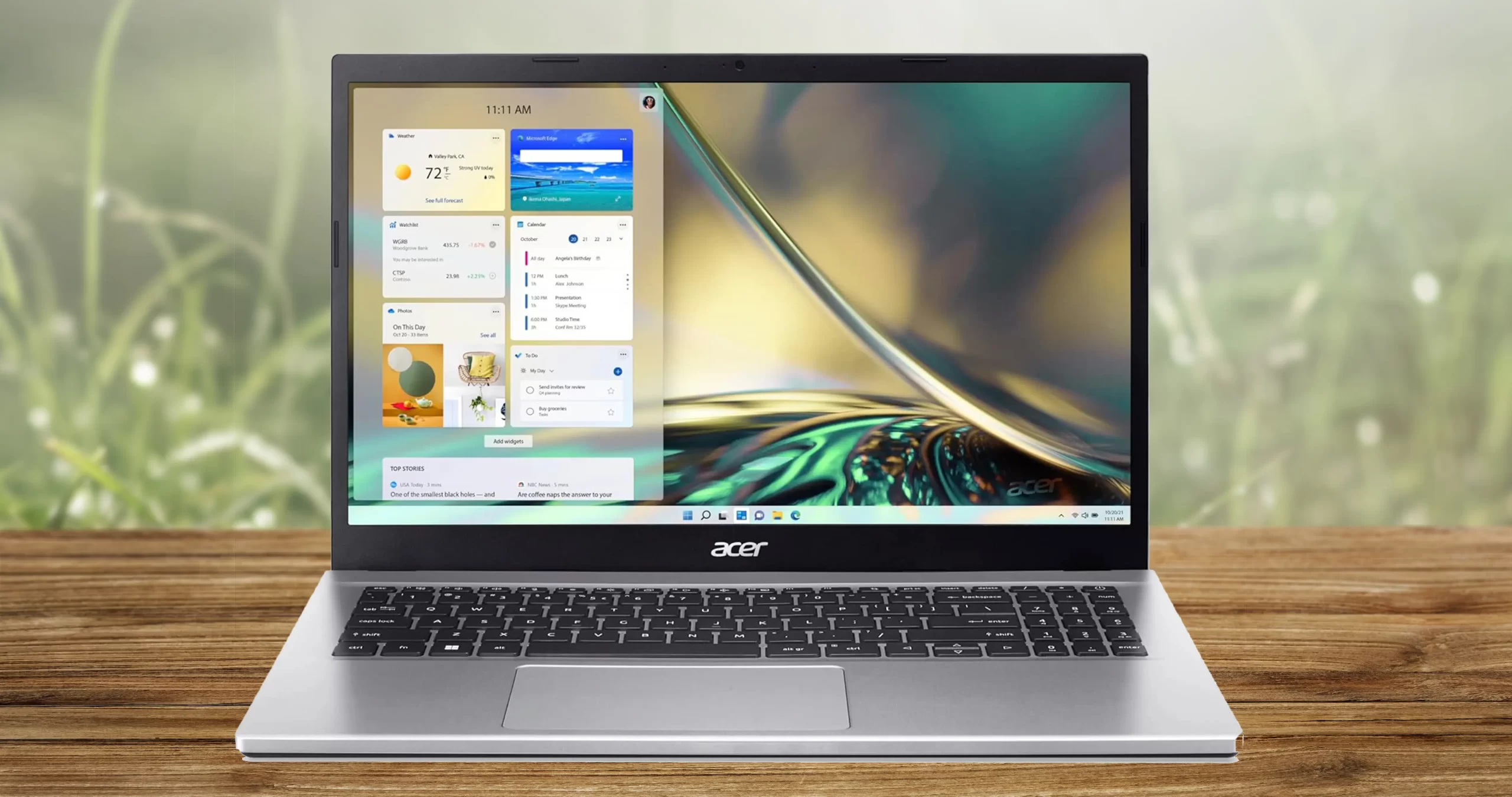 ilver Acer Aspire 3 A314-23 laptop open on a wooden desk, showcasing its 14-inch FHD matte display and minimalist keyboard design