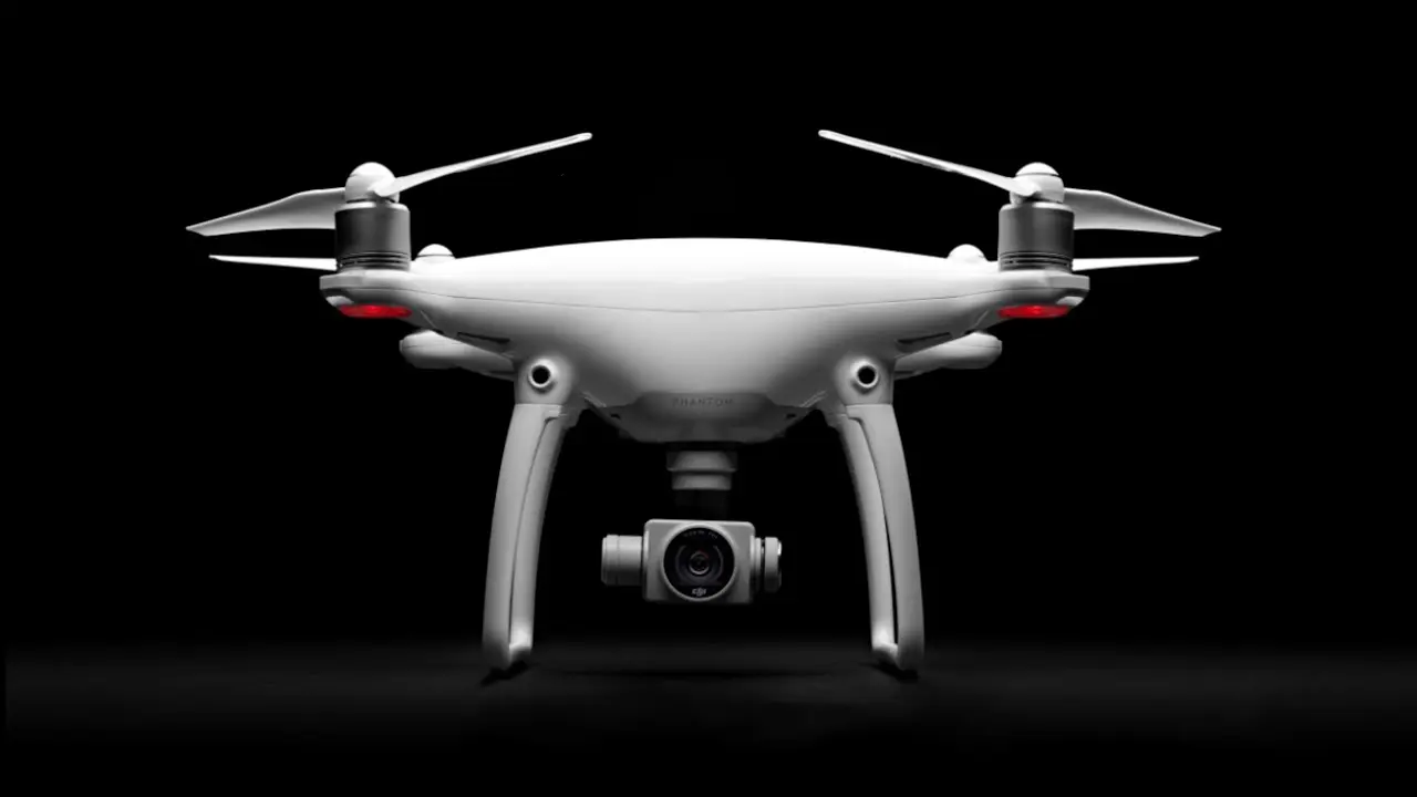 DJI Phantom 4 Pro drone in flight with 4K camera, showcasing professional design and obstacle-sensing technology.