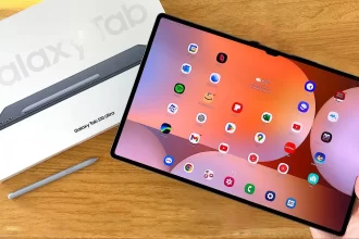 Samsung Galaxy Tab S10 Ultra tablet held in hand, showcasing its ultra-slim design, vibrant display, and multitasking capabilities with stylus and keyboard accessories.