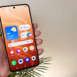 Samsung Galaxy A56 5G smartphone in Awesome Graphite color showing the 6.7-inch Super AMOLED display with slim metal frame and vertical camera bump."