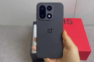 The new OnePlus 15 smartphone showing its flat display and triple camera module.